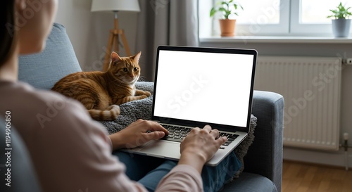 Mockup white screen laptop woman using computer and pet cat lying on sofa at home, back view, focus on screen