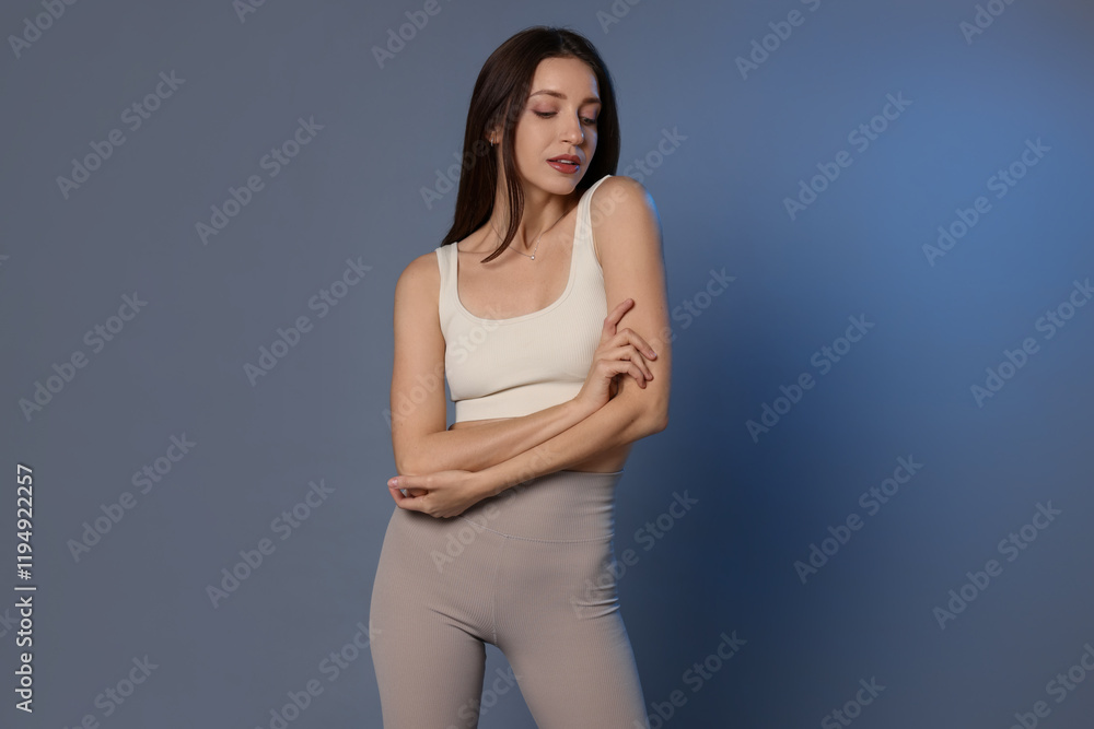 Beautiful woman in stylish sportswear on grey background Beautiful woman in stylish sportswear on grey background