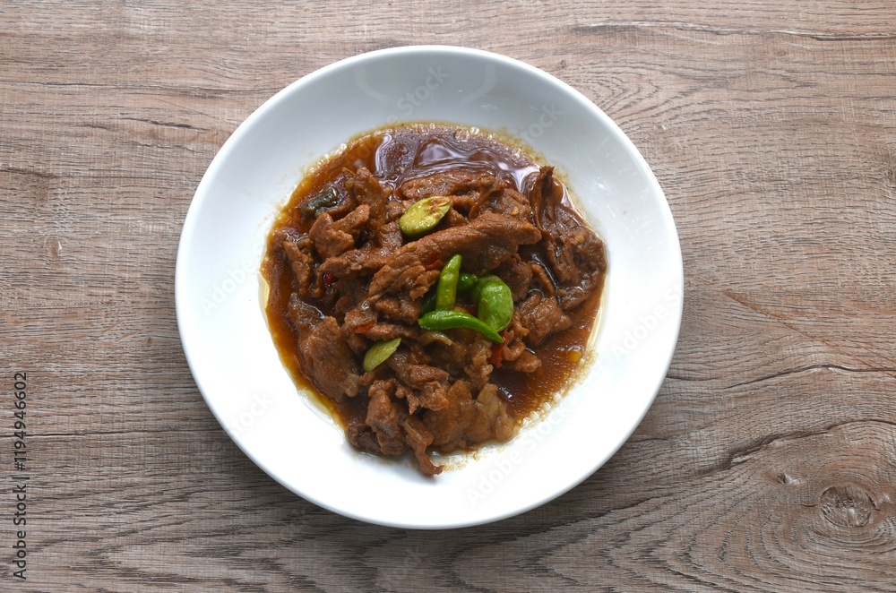 spicy stir fried slice pork with stink bean and chili in shrimp paste sauce on plate spicy stir fried slice pork with stink bean and chili in shrimp paste sauce on plate