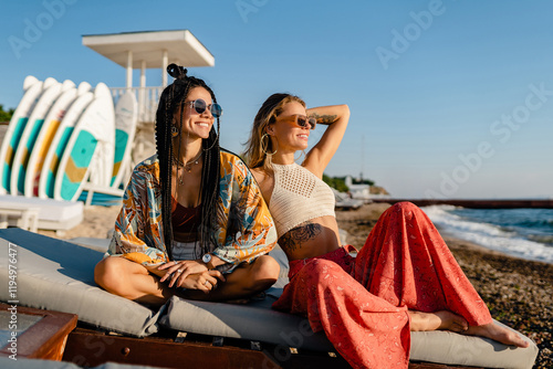 Canvas Print two stylish beautiful women relaxing having fun on beach in summer fashion trend