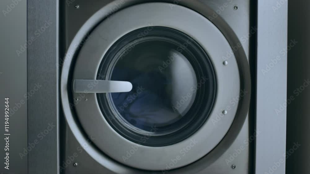 Loading clothes into a washer machine for efficient laundry cleaning at home Loading clothes into a washer machine for efficient laundry cleaning at home