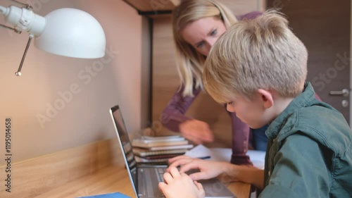 A mother, helping her son with his homework. They are using a laptop to search for information and solve tasks together.