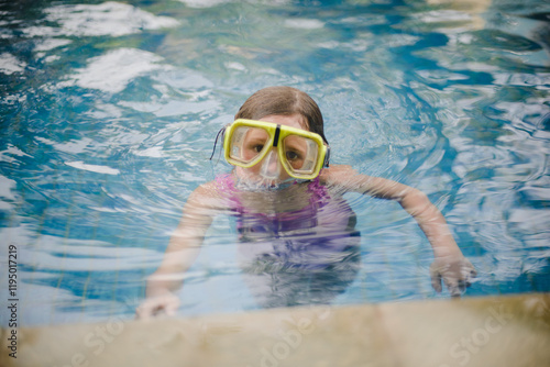 Girl child in the hotel pool