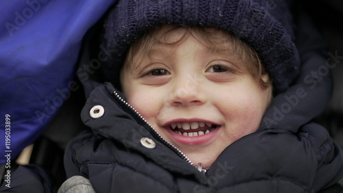Cute little baby boy face smiling wearing winter clothing, close-up face