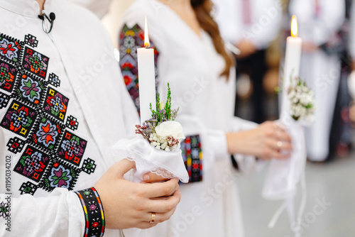 Canvas Print Couple wearing traditional Romanian costume holding candles during a religious c