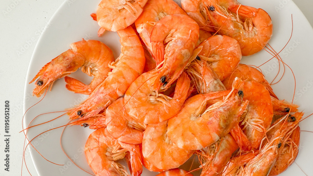 A plate of fresh, cooked shrimp symbolizes a delicious seafood meal, ideal for summer barbecues and festive gatherings A plate of fresh, cooked shrimp symbolizes a delicious seafood meal, ideal for summer barbecues and festive gatherings