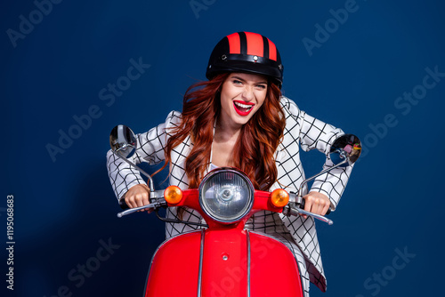 A cheerful young woman with red hair wearing a stylish checkered suit rides a red scooter against a dark blue backdrop