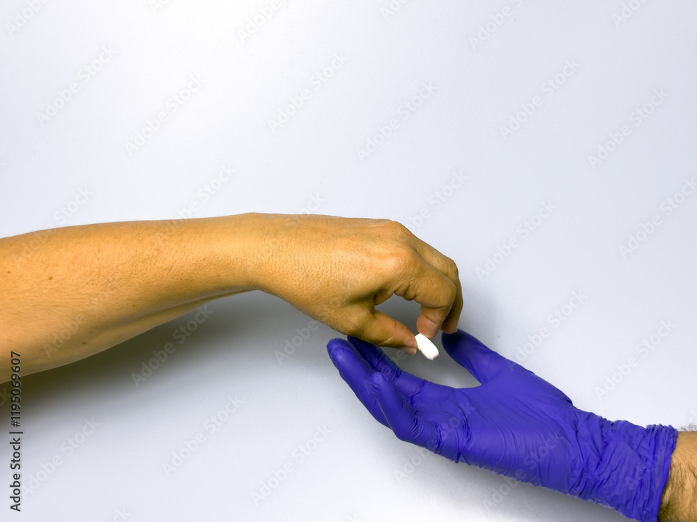 Fototapeta premium A person is giving a pill to another person