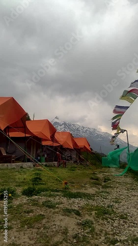 Vertical Time lapse shot of dark clouds above the camps in the campground during a stormy weather at Khangsar village in Lahaul and Spiti district, Himachal Pradesh, India. Natural background. photo