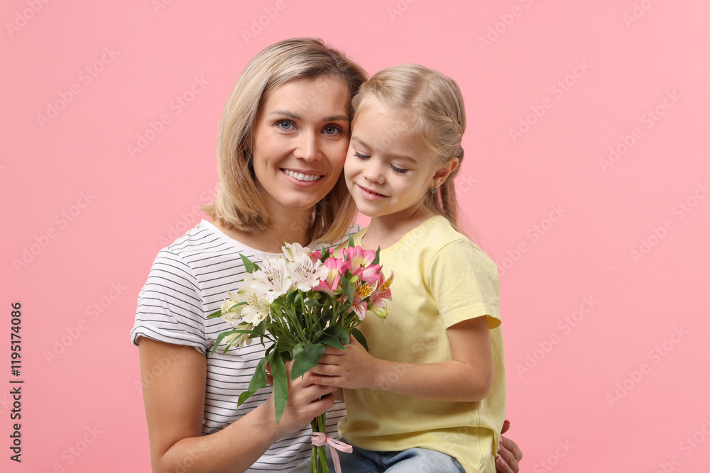 Little daughter congratulating her mom with bouquet of alstroemeria flowers on pink background. Happy Mother's Day Little daughter congratulating her mom with bouquet of alstroemeria flowers on pink background. Happy Mother's Day