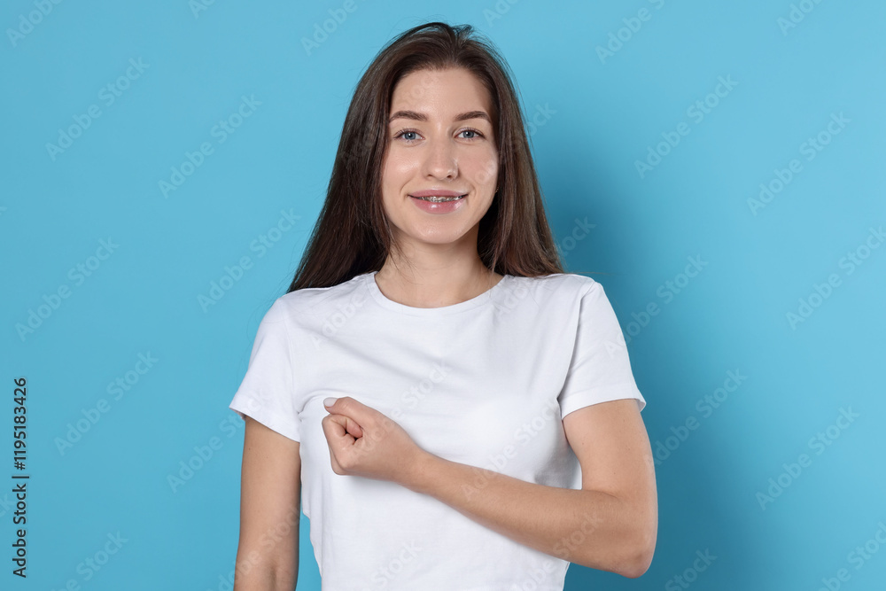 Woman making promise on light blue background. Oath gesture Woman making promise on light blue background. Oath gesture