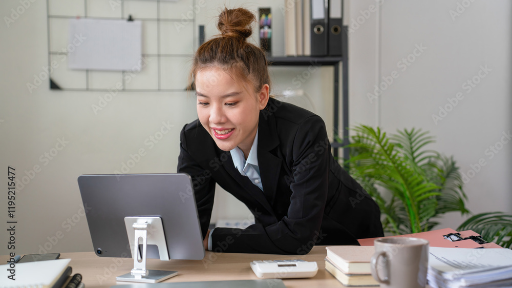 Businesswoman sitting at desk on couch in workplace or at home working on laptop and analyzing data on charts and graphs and writing on papers to make business plan and strategies for company. Businesswoman sitting at desk on couch in workplace or at home working on laptop and analyzing data on charts and graphs and writing on papers to make business plan and strategies for company.