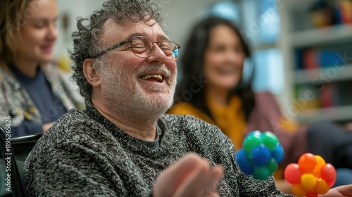 A mentally disabled adult in a supportive environment, engaging in a fun group activity photo