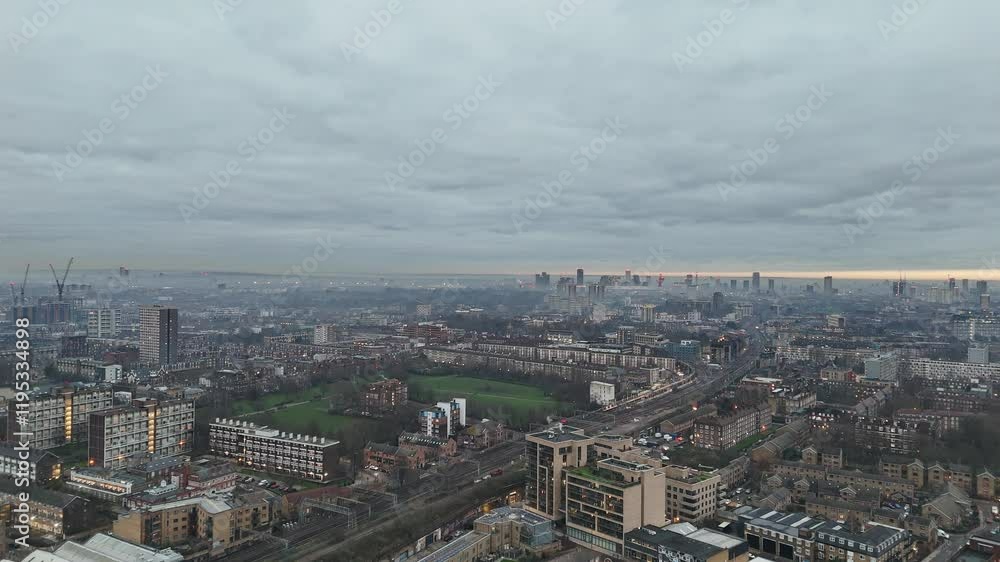 High altitude aerial view of the East End of London in early evening, showing the railway network and residential homes and apartments. High altitude aerial view of the East End of London in early evening, showing the railway network and residential homes and apartments.