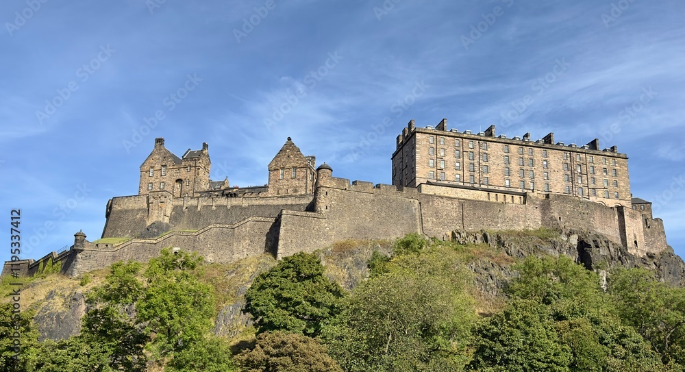 A low angle view of Edinburgh Castle against a blue sky background. A low angle view of Edinburgh Castle against a blue sky background.