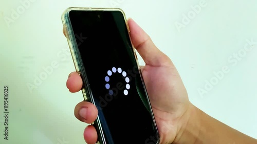 System error, slow loading, no connection to wifi on mobile smartphone screen in man hand. No signal internet connection on cellphone. System software update and upgrade loading process.