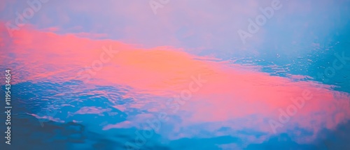 Colorful reflection of clouds on water at dawn creates a tranquil and serene atmosphere