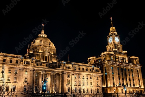 Photography Illuminated historic building at night in Shanghai.