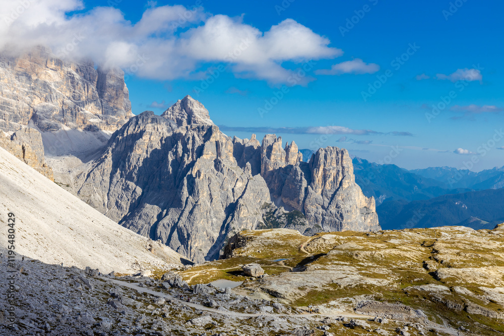 Dolomites rocky summits in the Alps. High tower peaks and sharp mountain rocky peaks of the Alps in the Dolomiti region, Italy. Beautiful scenic mountain range landscape in summer Dolomites rocky summits in the Alps. High tower peaks and sharp mountain rocky peaks of the Alps in the Dolomiti region, Italy. Beautiful scenic mountain range landscape in summer