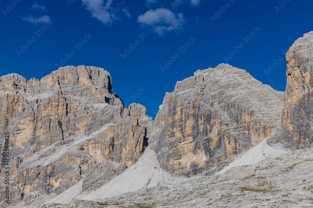 Dolomites rocky summits in the Alps. High tower peaks and sharp mountain rocky peaks of the Alps in the Dolomiti region, Italy. Beautiful scenic mountain range landscape in summer Dolomites rocky summits in the Alps. High tower peaks and sharp mountain rocky peaks of the Alps in the Dolomiti region, Italy. Beautiful scenic mountain range landscape in summer