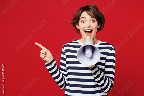 Fotografía Young surprised woman wear blue striped sweatshirt casual clothes hold in hand megaphone scream announces discounts sale Hurry up isolated on plain red background studio portrait