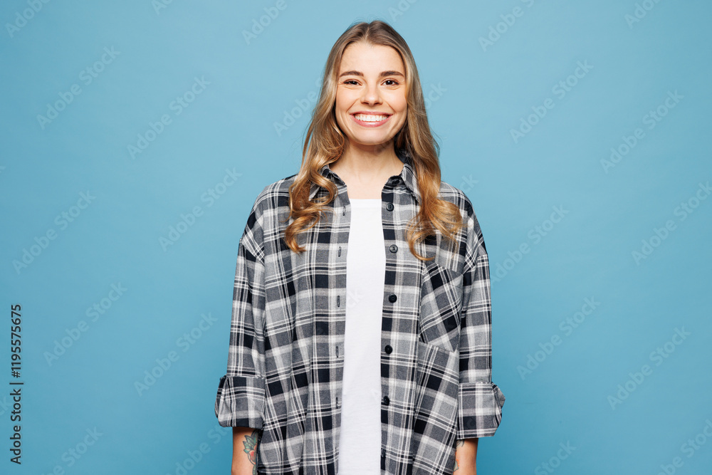Young smiling satisfied happy fun cheerful woman she wearing checkered shirt casual clothes looking camera isolated on plain pastel light blue cyan wall background studio portrait. Lifestyle concept. Young smiling satisfied happy fun cheerful woman she wearing checkered shirt casual clothes looking camera isolated on plain pastel light blue cyan wall background studio portrait. Lifestyle concept.