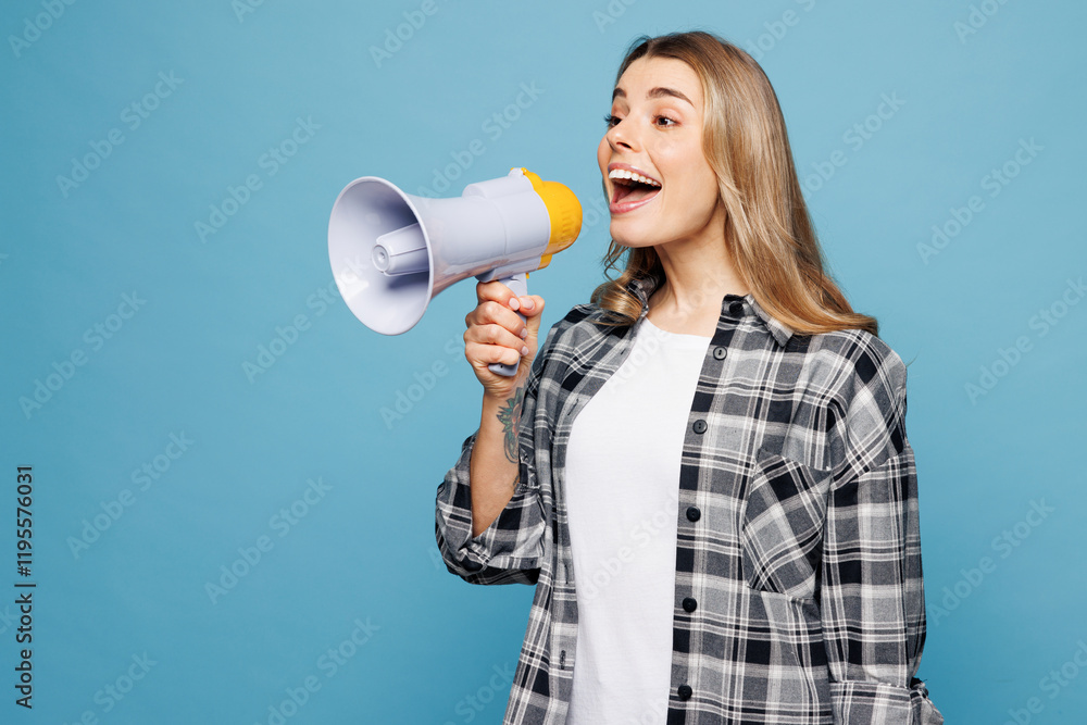Young surprised woman wears checkered grey shirt casual clothes hold in hand megaphone scream announces discounts sale Hurry up isolated on plain pastel light blue cyan background. Lifestyle concept. Young surprised woman wears checkered grey shirt casual clothes hold in hand megaphone scream announces discounts sale Hurry up isolated on plain pastel light blue cyan background. Lifestyle concept.