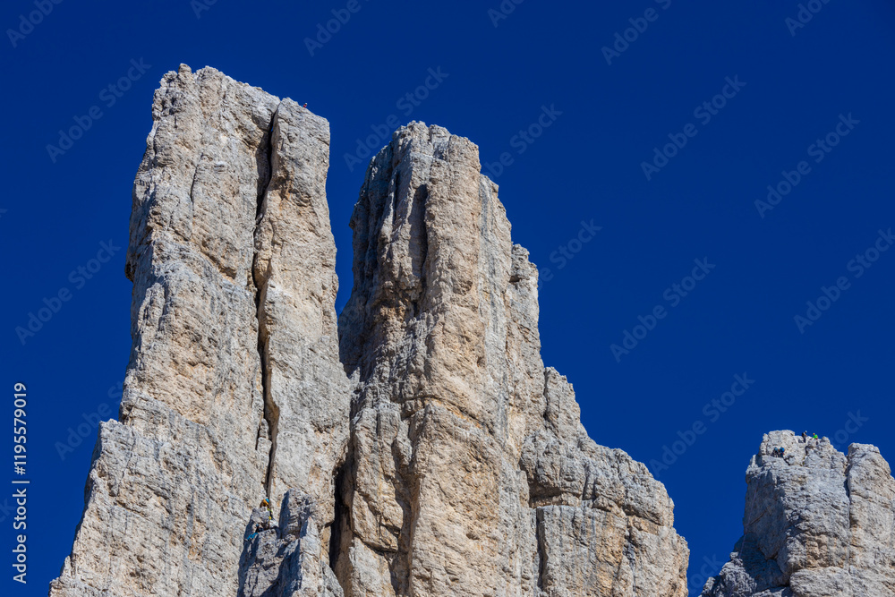 Dolomites rocky summits in the Alps. High tower peaks and sharp mountain rocky peaks of the Alps in the Dolomiti region, Italy. Beautiful scenic mountain range landscape in summer Dolomites rocky summits in the Alps. High tower peaks and sharp mountain rocky peaks of the Alps in the Dolomiti region, Italy. Beautiful scenic mountain range landscape in summer