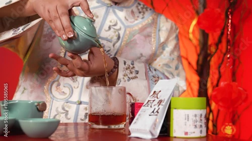 Chinese woman preparing tea in traditional way, close up, brewing tea