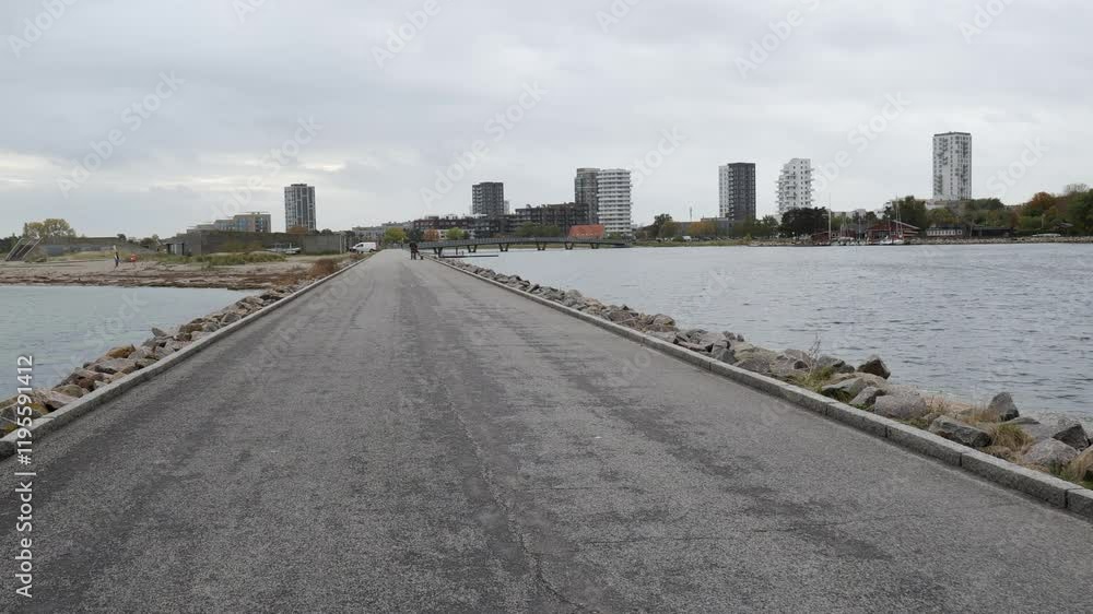 Walking on the asphalt road near the sea. Beautiful landscape around. Slow motion Walking on the asphalt road near the sea. Beautiful landscape around. Slow motion