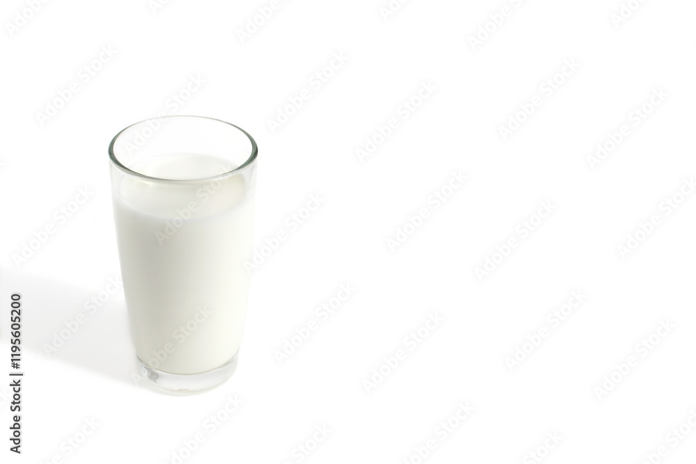 A glass of milk stands on a white background. A glass of milk stands on a white background.
