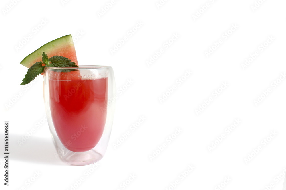 There is a transparent glass with watermelon juice on a white background. There is a transparent glass with watermelon juice on a white background.