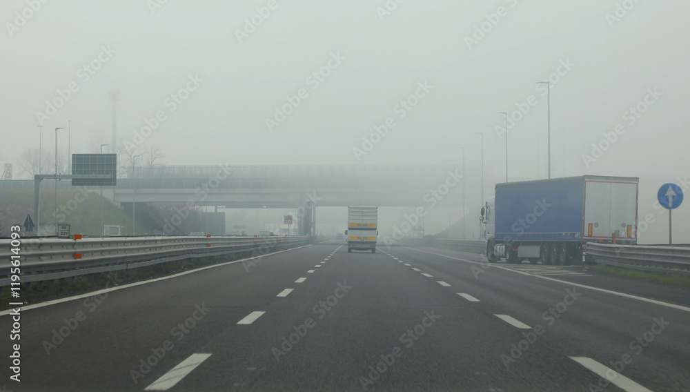 lots of fog and poor visibility on the highway with a truck coming from the right lots of fog and poor visibility on the highway with a truck coming from the right