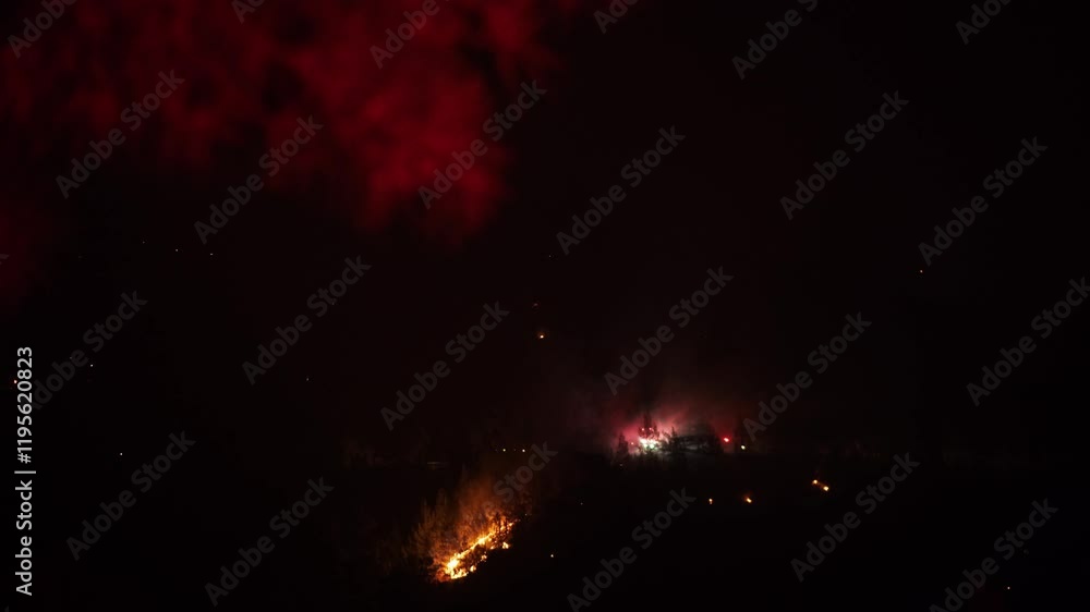 Wildfire at night and fire trucks.View forest fire on the slopes of hills and mountains. Fire fighters with safety equipment, fire in forest. Firefighters are helping extinguish forest fires. Wildfire at night and fire trucks.View forest fire on the slopes of hills and mountains. Fire fighters with safety equipment, fire in forest. Firefighters are helping extinguish forest fires.