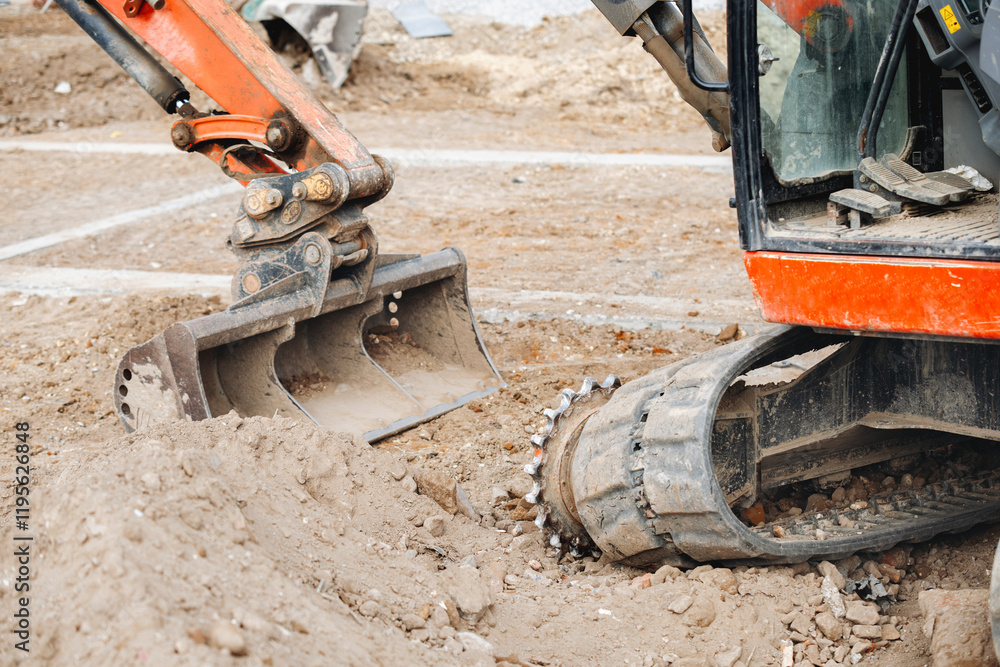 Fototapeta premium Broken excavator without track on building site awaiting repair