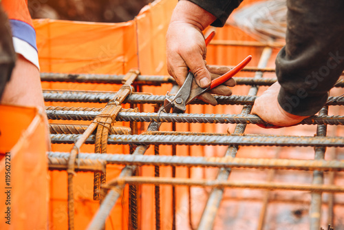 Construction workers assembling steel reinforcement bars at a building site photo