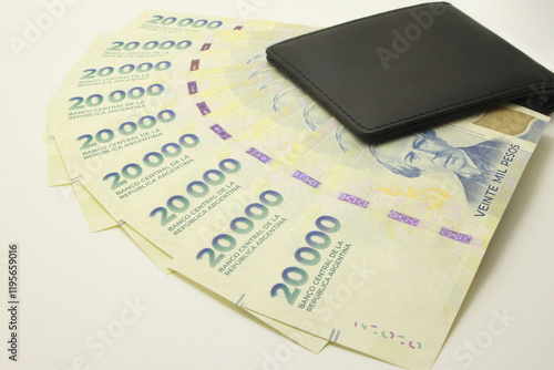 Argentine Money, Currency of Argentine, Pesos argentinos, various bills inside a wallet, close-up on white background. Twenty thousand cash bills