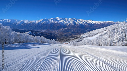 Snowy mountain ski slope with groomed runs.