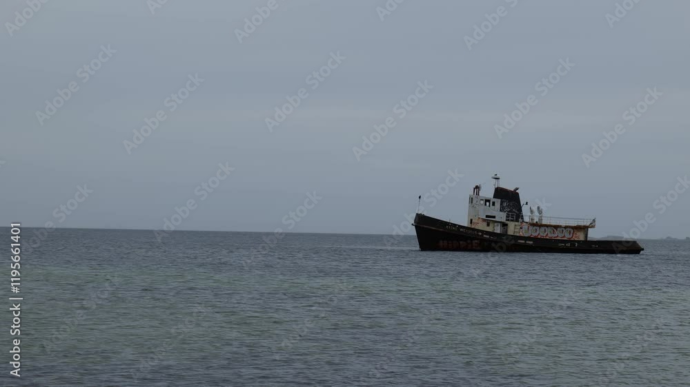 View of the ship rusty and old at sea against the sky. Sea and sky background, gray gloomy weather. Transport at sea