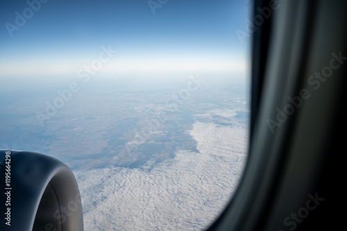 View from the airplane window on beautiful clouds. View of the earth from above. Low-cost flight.
