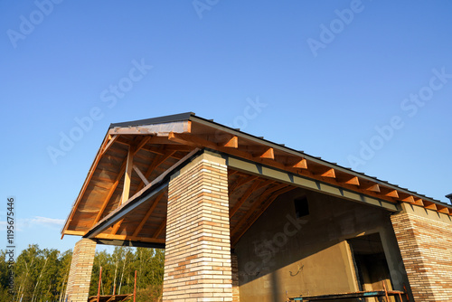 Wallpaper Mural Roof Construction of Unfinished Suburb House. Suburb House construction. New house under construction in suburban neighborhood. Wooden framework of roof home. Roof installation, roofing works. Torontodigital.ca