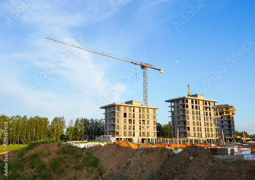 Construction site with jib crane. Construction of Residential Building. Tower Crane on formworks. Apartments House Construction. Tower Cranes on Residential buildings Construction, housing renovation. photo