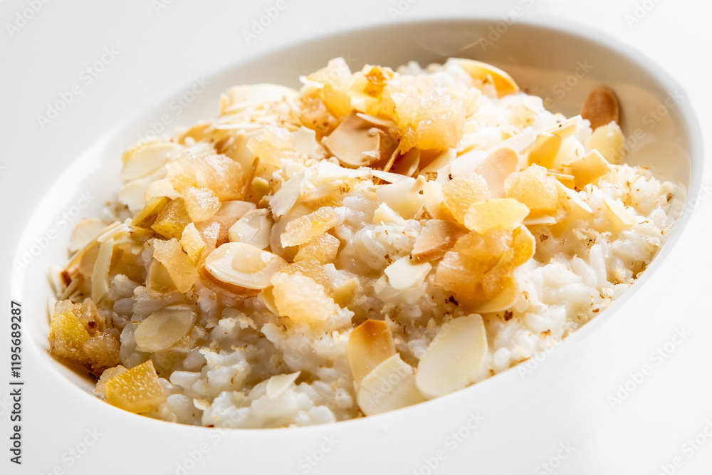 Creamy rice pudding topped with slivers of almond and sweet caramelized pieces. Perfect for dessert lovers, this dish showcases a delicious blend of textures and flavors. Ideal for food photography. Creamy rice pudding topped with slivers of almond and sweet caramelized pieces. Perfect for dessert lovers, this dish showcases a delicious blend of textures and flavors. Ideal for food photography.