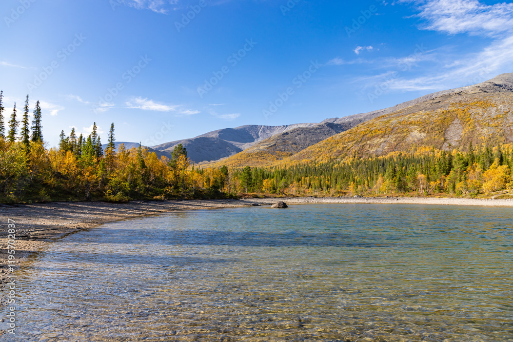 Scenic view of Khibiny mountains with small lake on foreground. Autumn colored landscape of arctic tundra Murmans region. Kola Peninsula, Russia.