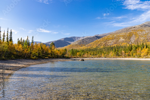 Obraz na płótnie Scenic view of Khibiny mountains with small lake on foreground. Autumn colored landscape of arctic tundra Murmans region. Kola Peninsula, Russia. w salonie