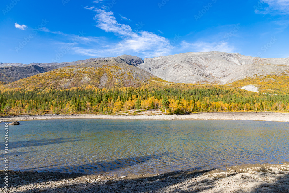 Scenic view of Khibiny mountains with North Chorrgor pass with small lake on foreground. Kola Peninsula, Murmansk region, Russia.