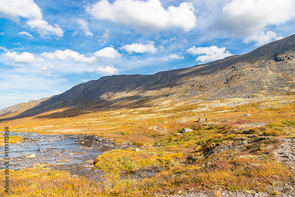 View to Petrelius river valley at Khibiny mountains. Early autumn in arctic tundra region. Kola peninsula, Murmansk region, Russia.