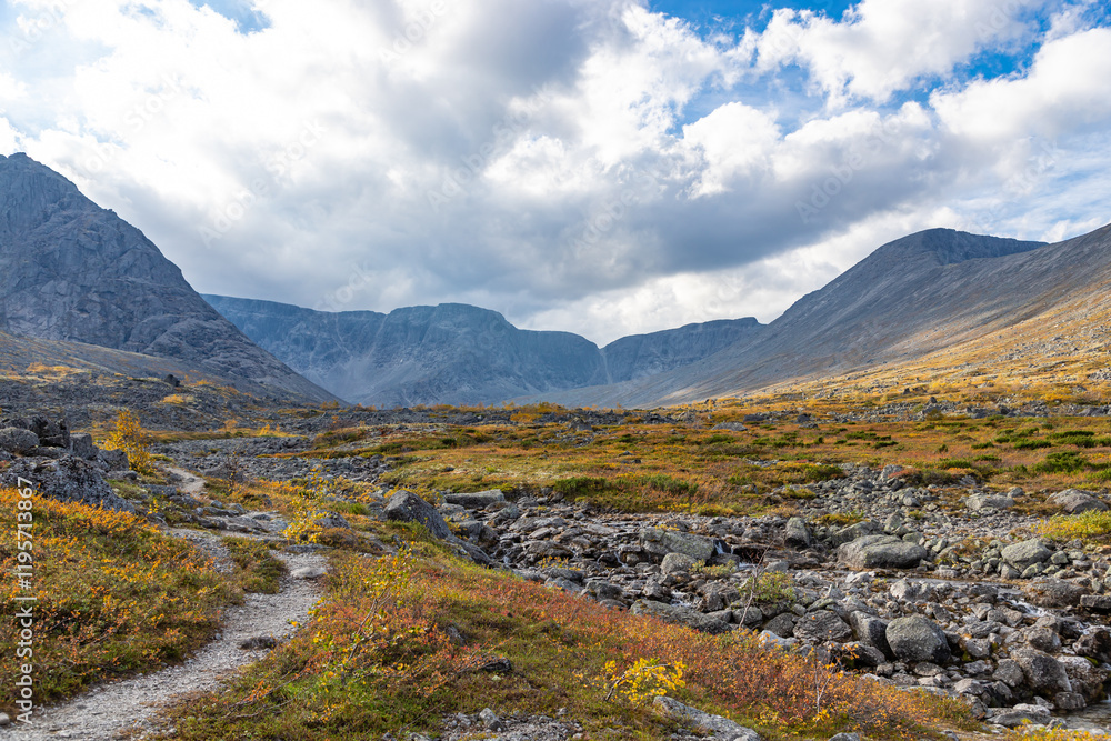 View to Petrelius river valley at Khibiny mountains. Early autumn in arctic tundra region. Kola peninsula, Murmansk region, Russia. View to Petrelius river valley at Khibiny mountains. Early autumn in arctic tundra region. Kola peninsula, Murmansk region, Russia.