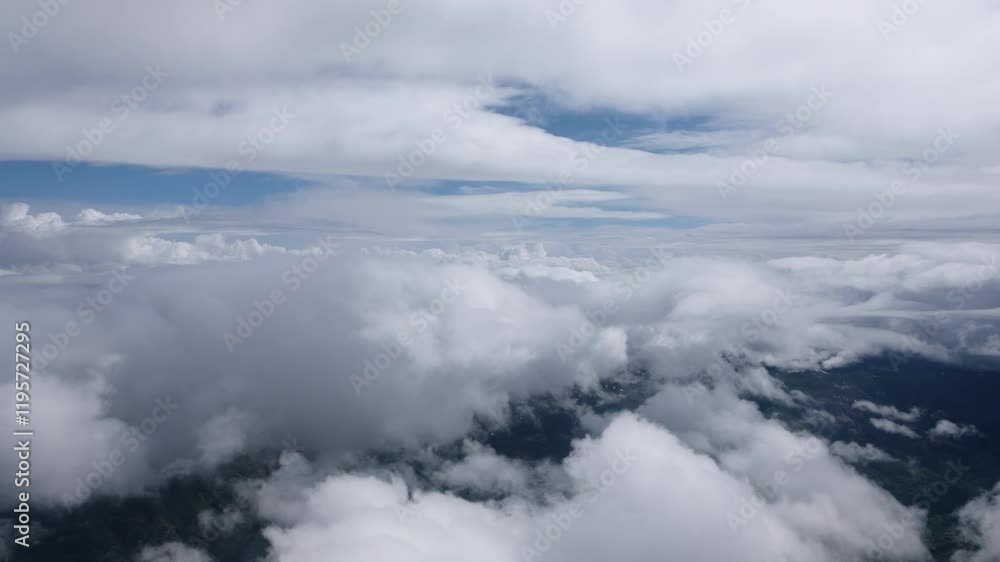 Thick clouds seen from above, captured in a mesmerizing aerial video through the plane window during a flight. Thick clouds seen from above, captured in a mesmerizing aerial video through the plane window during a flight.