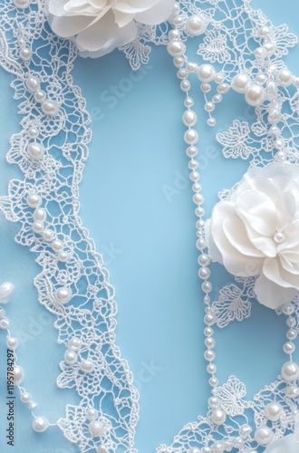 Elegant white lace, pearls, and flowers on blue background for wedding invitation design